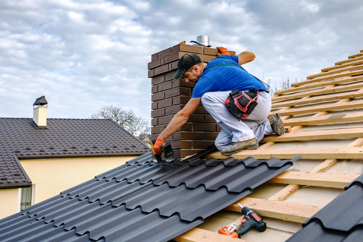 roofing being installed by a roof tech on a sloped roof