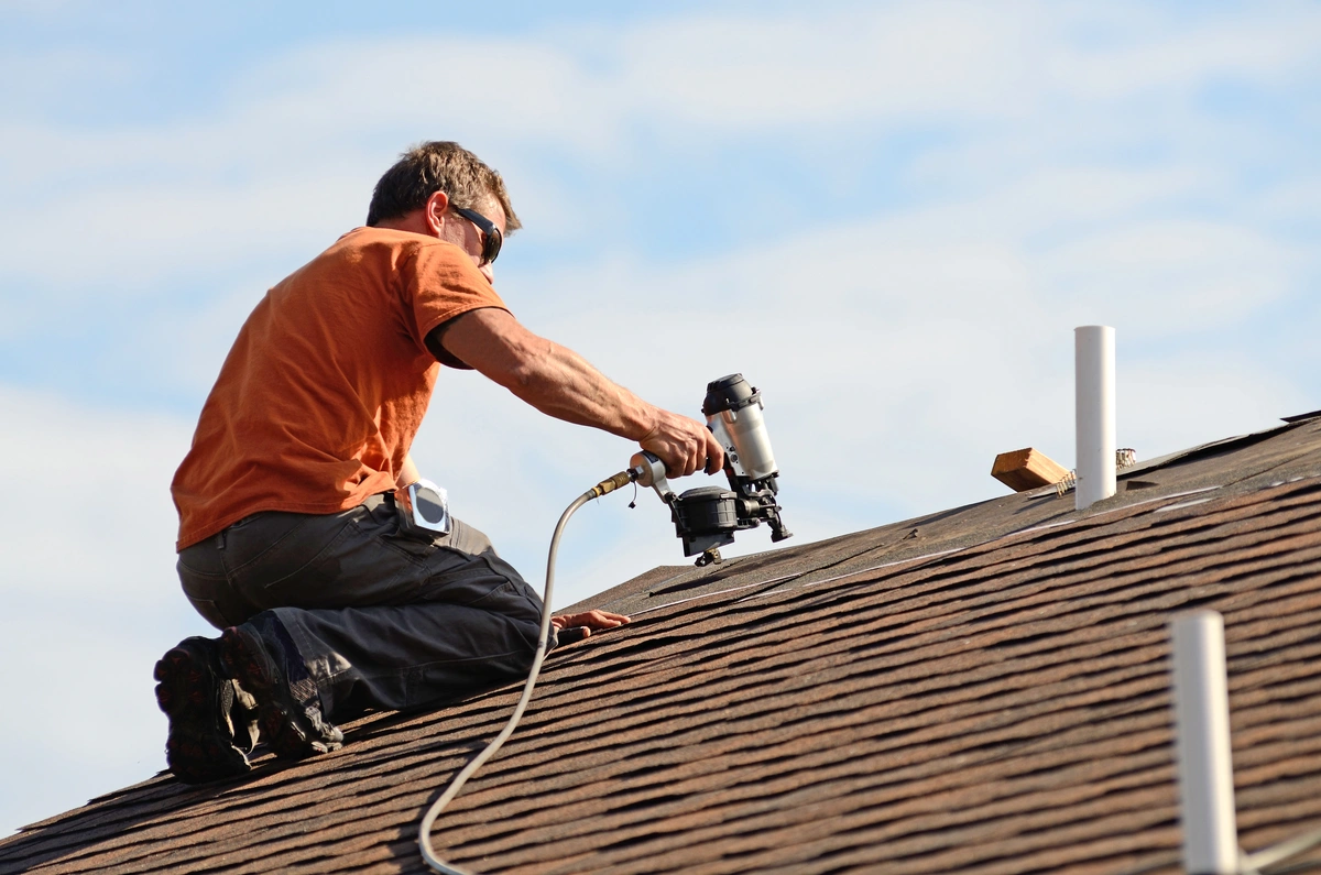 roof tech installing roofing shingles with power tools